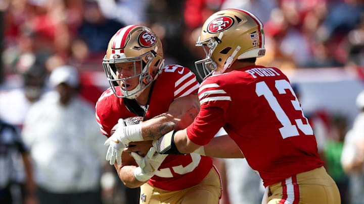 Nov 10, 2024; Tampa, Florida, USA; San Francisco 49ers quarterback Brock Purdy (13) hands off to running back Christian McCaffrey (23) against the Tampa Bay Buccaneers in the first quarter at Raymond James Stadium. Mandatory Credit: Nathan Ray Seebeck-Imagn Images