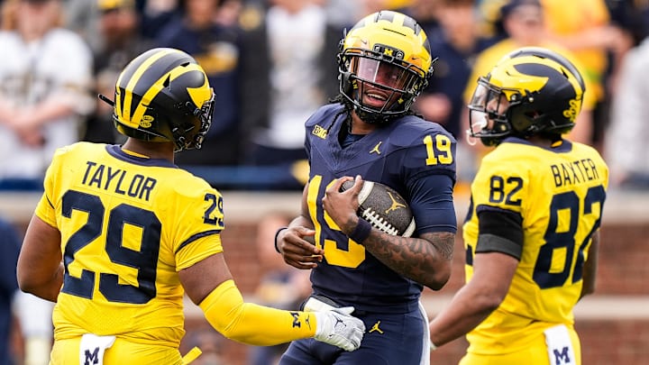 Team Blue Michigan quarterback Bryce Underwood (19) tries to run after recovering his fumble during the second half of the spring game at Michigan Stadium in Ann Arbor on Saturday, April 19, 2025.