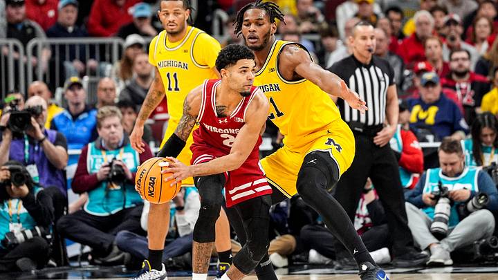 Michigan forward Morez Johnson Jr. (21) defends Wisconsin guard Nick Boyd (2) during the second half of Big Ten Tournament semifinal at United Center in Chicago on Saturday, March 14, 2026. Michigan forward Morez Johnson Jr. (21) defends Wisconsin guard Nick Boyd (2) during the second half of Big Ten Tournament semifinal at United Center in Chicago on Saturday, March 14, 2026.