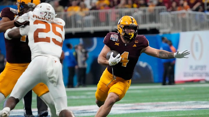 Arizona State running back Cam Skattebo (4) runs against Texas defensive back Jelani McDonald (25) during the third quarter of the Chick-fil-A Peach Bowl in Atlanta on Jan. 1, 2025. Arizona State running back Cam Skattebo (4) runs against Texas defensive back Jelani McDonald (25) during the third quarter of the Chick-fil-A Peach Bowl in Atlanta on Jan. 1, 2025.