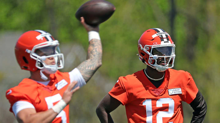Cleveland Browns quarterback Shedeur Sanders watches as quarterback Dillon Gabriel throws during rookie minicamp