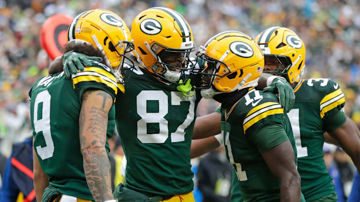 Green Bay Packers wide receiver Romeo Doubs (87) celebrates scoring a touchdown with wide receiver Christian Watson (9), wide receiver Jayden Reed (11), and running back Emanuel Wilson (31) against the Arizona Cardinals during their football game Sunday.