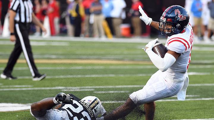 Mississippi Rebels wide receiver Jordan Watkins is tackled for a loss by Vanderbilt Commodores defensive back Jaylen Mahoney 