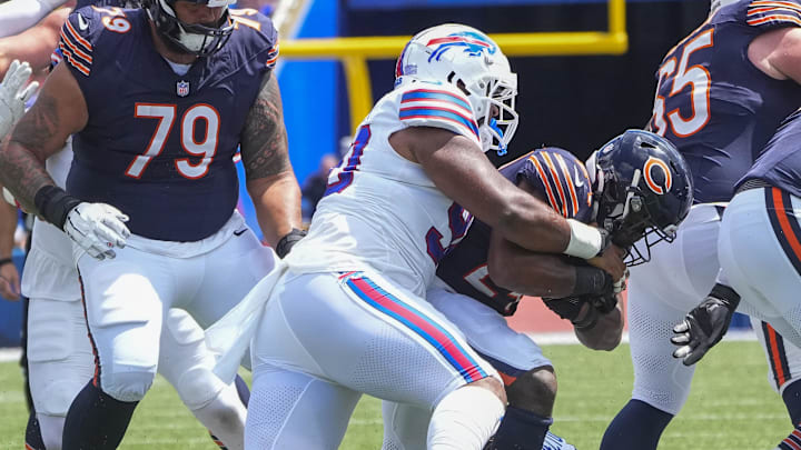 Aug 10, 2024; Orchard Park, New York, USA; Buffalo Bills defensive tackle DeWayne Carter (90) tackles Chicago Bears running back Khalil Herbert (24) during the first half at Highmark Stadium. 