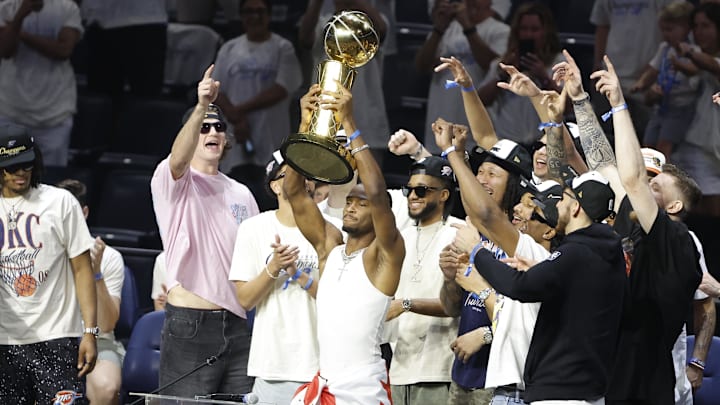 Oklahoma City Thunder guard Shai Gilgeous-Alexander holds up the Larry O'Brien Trophy