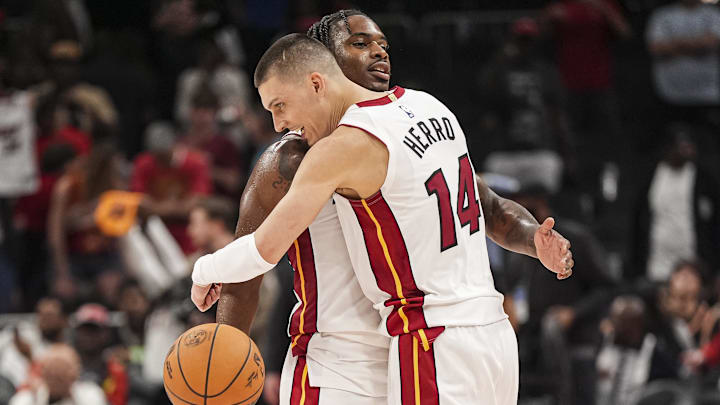 Apr 18, 2025; Atlanta, Georgia, USA; Miami Heat guard Davion Mitchell (45) and guard Tyler Herro (14) react after defeating the Atlanta Hawks in overtime at State Farm Arena. Mandatory Credit: Dale Zanine-Imagn Images