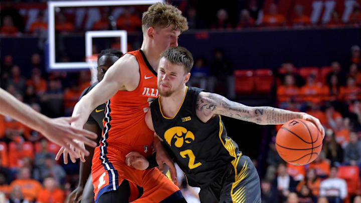 Feb 25, 2025; Champaign, Illinois, USA; Iowa Hawkeyes guard Brock Harding (2) drives the ball against Illinois Fighting Illini guard Kasparas Jakucionis (32) during the second half at State Farm Center. Mandatory Credit: Ron Johnson-Imagn Images Feb 25, 2025; Champaign, Illinois, USA; Iowa Hawkeyes guard Brock Harding (2) drives the ball against Illinois Fighting Illini guard Kasparas Jakucionis (32) during the second half at State Farm Center. Mandatory Credit: Ron Johnson-Imagn Images