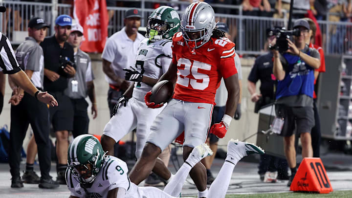 Sep 13, 2025; Columbus, Ohio, USA;  Ohio State Buckeyes running back Bo Jackson (25) reacts after a long run as Ohio Bobcats cornerback Michael Mack II (9) makes the tackle during the second half at Ohio Stadium. Mandatory Credit: Joseph Maiorana-Imagn Images
