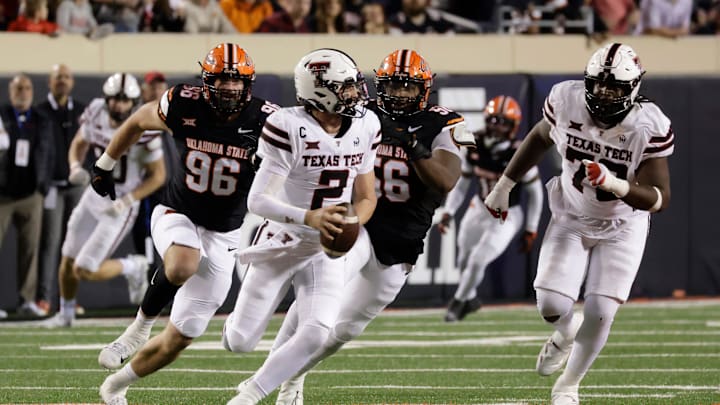 Texas Tech's Behren Morton runs the ball against Oklahoma State's Kody Walterscheid and Xavier Ross while Texas Tech's Sterling Porcher looks on during an NCAA football game on Saturday, Nov. 23, 2024, in Stillwater, Okla.