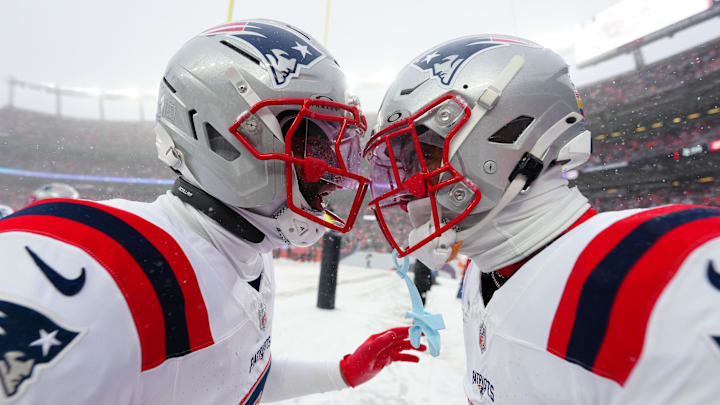 Jan 25, 2026; Denver, CO, USA;  New England Patriots cornerback Christian Gonzalez (0) and cornerback Carlton Davis III (7)  react after an interception during the 2026 AFC Championship Game at Empower Field at Mile High. Mandatory Credit: Ron Chenoy-Imagn Images