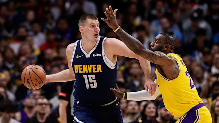 Apr 29, 2024; Denver, Colorado, USA; Denver Nuggets center Nikola Jokic (15) controls the ball under pressure from Los Angeles Lakers forward LeBron James (23) in the first quarter during game five of the first round for the 2024 NBA playoffs at Ball Arena. Mandatory Credit: Isaiah J. Downing-Imagn Images