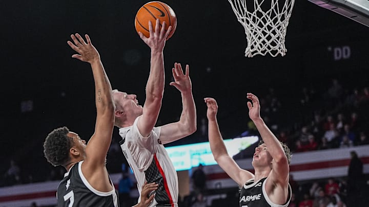 Nov 3, 2025; Athens, Georgia, USA; Georgia Bulldogs guard Blue Cain (0) shoots between Bellarmine Knights forward Donovan Hunter (7) and guard Tyler Doyle (2) at Stegeman Coliseum. Mandatory Credit: Dale Zanine-Imagn Images