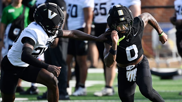 Vanderbilt wide receiver Junior Sherrill (0) runs a route against cornerback Cayden Daniels (26) during fall practice Wednesday, July 30, 2025, in Nashville, Tenn. Vanderbilt wide receiver Junior Sherrill (0) runs a route against cornerback Cayden Daniels (26) during fall practice Wednesday, July 30, 2025, in Nashville, Tenn.
