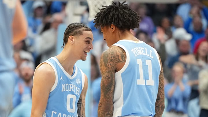 Dec 30, 2025; Chapel Hill, North Carolina, USA; North Carolina Tar Heels guard Kyan Evans (0) and forward Jonathan Powell (11) react in the second half at Dean E. Smith Center. Mandatory Credit: Bob Donnan-Imagn Images Dec 30, 2025; Chapel Hill, North Carolina, USA; North Carolina Tar Heels guard Kyan Evans (0) and forward Jonathan Powell (11) react in the second half at Dean E. Smith Center. Mandatory Credit: Bob Donnan-Imagn Images
