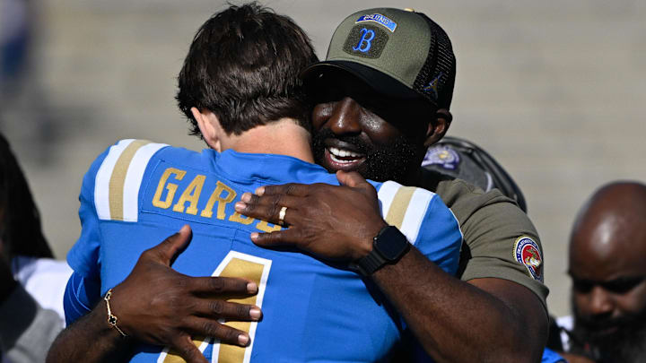 Nov 30, 2024; Pasadena, California, USA; UCLA Bruins head coach DeShaun Foster hugs UCLA Bruins quarterback Ethan Garbers (4) during pregame “senior day” ceremonies before playing the  Fresno State Bulldogs at Rose Bowl. Mandatory Credit: Robert Hanashiro-Imagn Images