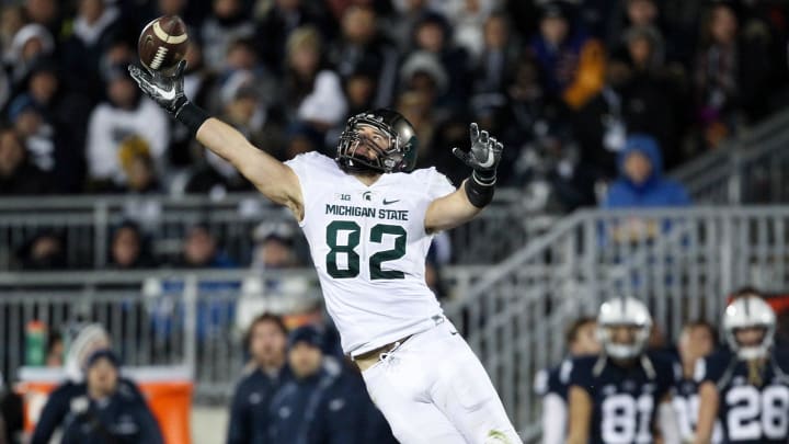 Nov 26, 2016; University Park, PA, USA; Michigan State Spartans tight end Josiah Price (82) attempts a catch during the third quarter against the Penn State Nittany Lions at Beaver Stadium. Penn State defeated Michigan State 45-12. Mandatory Credit: Matthew O'Haren-USA TODAY Sports