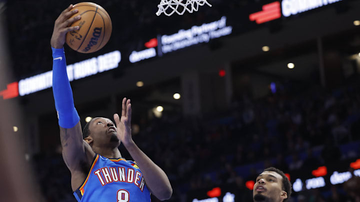 Jan 13, 2026; Oklahoma City, Oklahoma, USA; Oklahoma City Thunder guard/forward Jalen Williams (8) shoots beside San Antonio Spurs forward/center Victor Wembanyama (1) during the second half at Paycom Center. Mandatory Credit: Alonzo Adams-Imagn Images