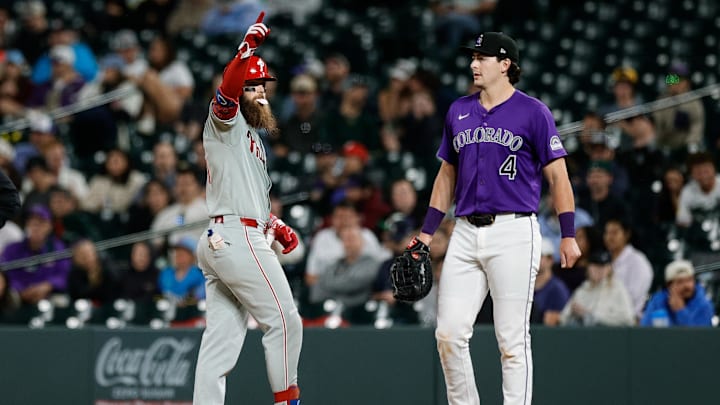 Denver, Colorado, USA; Philadelphia Phillies center fielder Brandon Marsh (16) reacts ahead of Colorado Rockies first baseman Michael Toglia (4) after hitting a single in the ninth inning at Coors Field.