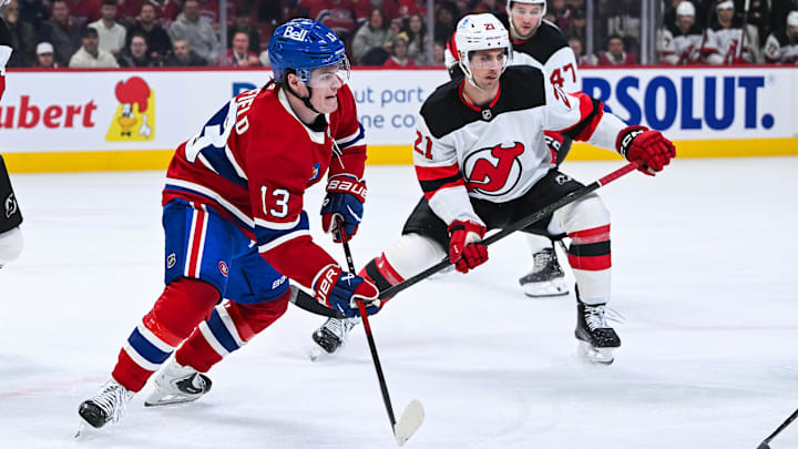 Apr 5, 2026; Montreal, Quebec, CAN; Montreal Canadiens right wing Cole Caufield (13) plays the puck against New Jersey Devils center Marc McLaughlin (21) during the first period at Bell Centre. Mandatory Credit: David Kirouac-Imagn Images Apr 5, 2026; Montreal, Quebec, CAN; Montreal Canadiens right wing Cole Caufield (13) plays the puck against New Jersey Devils center Marc McLaughlin (21) during the first period at Bell Centre. Mandatory Credit: David Kirouac-Imagn Images