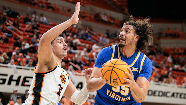 Feb 24, 2026; Stillwater, Oklahoma, USA; West Virginia Mountaineers center Harlan Obioha (55) drives around Oklahoma State Cowboys forward Parsa Fallah (22) during the second half at Gallagher-Iba Arena. Mandatory Credit: William Purnell-Imagn Images Feb 24, 2026; Stillwater, Oklahoma, USA; West Virginia Mountaineers center Harlan Obioha (55) drives around Oklahoma State Cowboys forward Parsa Fallah (22) during the second half at Gallagher-Iba Arena. Mandatory Credit: William Purnell-Imagn Images