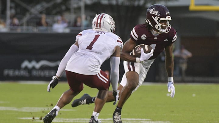 Nov 2, 2024; Starkville, Mississippi, USA; Mississippi State Bulldogs wide receiver Kelly Akharaiyi (1) runs the ball against Massachusetts Minutemen defensive back Arsheen Jiles (1) during the fourth quarter at Davis Wade Stadium at Scott Field. Mandatory Credit: Matt Bush-Imagn Images