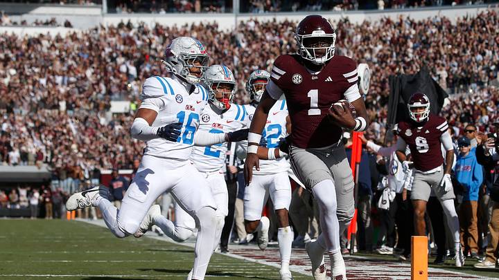Nov 28, 2025; Starkville, Mississippi, USA; Mississippi State Bulldogs quarterback Kamario Taylor (1) runs to score a touchdown against the Mississippi Rebels in the first half at Davis Wade Stadium at Scott Field. Mandatory Credit: Petre Thomas-Imagn Images Nov 28, 2025; Starkville, Mississippi, USA; Mississippi State Bulldogs quarterback Kamario Taylor (1) runs to score a touchdown against the Mississippi Rebels in the first half at Davis Wade Stadium at Scott Field. Mandatory Credit: Petre Thomas-Imagn Images