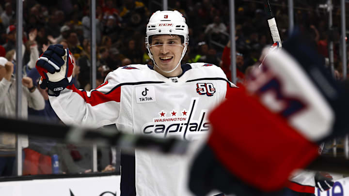 Washington Capitals right wing Ryan Leonard smiles as he celebrates a goal by teammate center Dylan Strome.