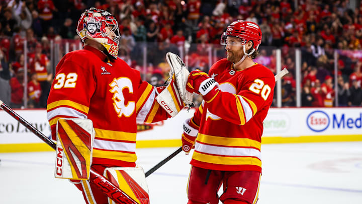 Calgary Flames goaltender Dustin Wolf celebrates a win with teammates after defeating Vegas Golden Knights.