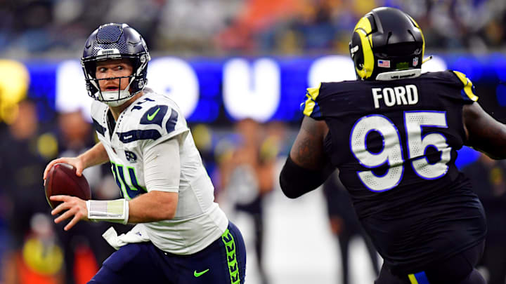 Nov 16, 2025; Inglewood, California, USA; Seattle Seahawks quarterback Sam Darnold (14) rolls out to pass against Los Angeles Rams defensive tackle Poona Ford (95) during the second half at SoFi Stadium. Mandatory Credit: Gary A. Vasquez-Imagn Images Nov 16, 2025; Inglewood, California, USA; Seattle Seahawks quarterback Sam Darnold (14) rolls out to pass against Los Angeles Rams defensive tackle Poona Ford (95) during the second half at SoFi Stadium. Mandatory Credit: Gary A. Vasquez-Imagn Images
