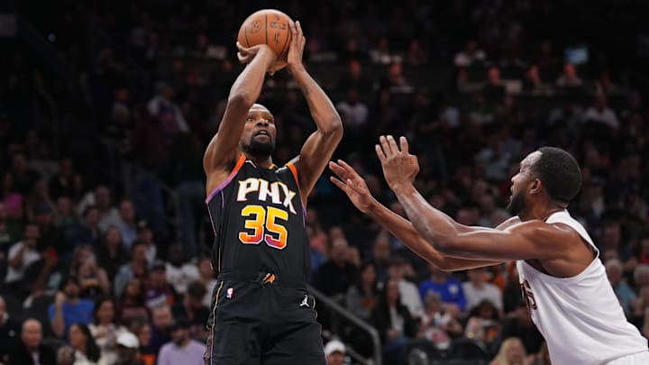 Mar 21, 2025; Phoenix, Arizona, USA; Phoenix Suns forward Kevin Durant (35) shoots against Cleveland Cavaliers forward Evan Mobley (4) during the second half at Footprint Center. Mandatory Credit: Joe Camporeale-Imagn Images