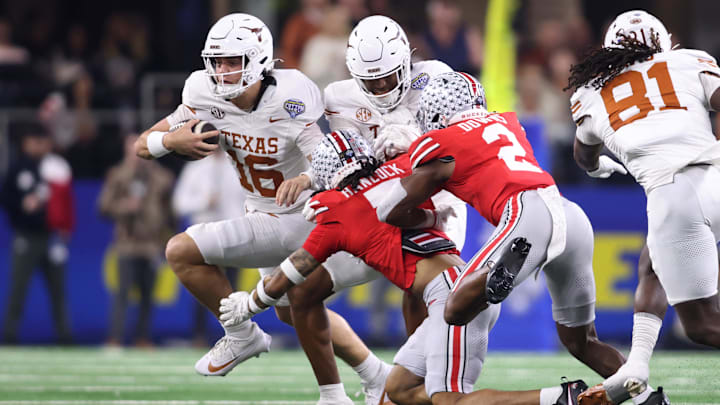 Jan 10, 2025; Arlington, Texas, USA; Texas Longhorns quarterback Arch Manning (16) runs against Ohio State Buckeyes cornerback Jordan Hancock (7) and safety Caleb Downs (2) during the second quarter of the College Football Playoff semifinal in the Cotton Bowl at AT&T Stadium. Mandatory Credit: Tim Heitman-Imagn Images Jan 10, 2025; Arlington, Texas, USA; Texas Longhorns quarterback Arch Manning (16) runs against Ohio State Buckeyes cornerback Jordan Hancock (7) and safety Caleb Downs (2) during the second quarter of the College Football Playoff semifinal in the Cotton Bowl at AT&T Stadium. Mandatory Credit: Tim Heitman-Imagn Images