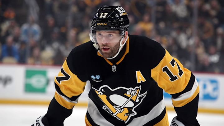 Jan 11, 2025; Pittsburgh, Pennsylvania, USA;  Pittsburgh Penguins right wing Bryan Rust (17) looks on at the face-off circle against the Ottawa Senators during the first period at PPG Paints Arena. Mandatory Credit: Charles LeClaire-Imagn Images