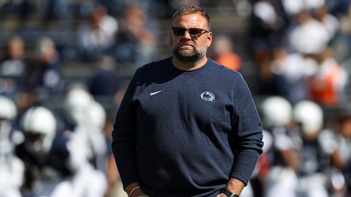 Penn State Nittany Lions offensive coordinator Andy Kotelnicki walks on the field during a warm-up prior to a 2024 college football game at Beaver Stadium. 