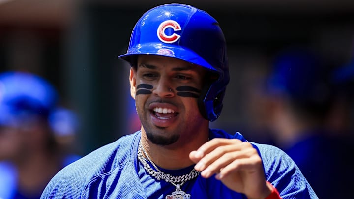 Jun 9, 2024; Cincinnati, Ohio, USA; Chicago Cubs third baseman Christopher Morel (5) high fives teammates after scoring on a three-run double hit by outfielder Ian Happ (not pictured) in the first inning against the Cincinnati Reds at Great American Ball Park