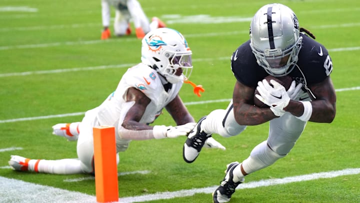 Nov 17, 2024; Miami Gardens, Florida, USA; Las Vegas Raiders running back Ameer Abdullah (8) scores a touchdown past Miami Dolphins safety Jevon Holland (8) in the fourth quarter at Hard Rock Stadium. Mandatory Credit: Jim Rassol-Imagn Images Nov 17, 2024; Miami Gardens, Florida, USA; Las Vegas Raiders running back Ameer Abdullah (8) scores a touchdown past Miami Dolphins safety Jevon Holland (8) in the fourth quarter at Hard Rock Stadium. Mandatory Credit: Jim Rassol-Imagn Images
