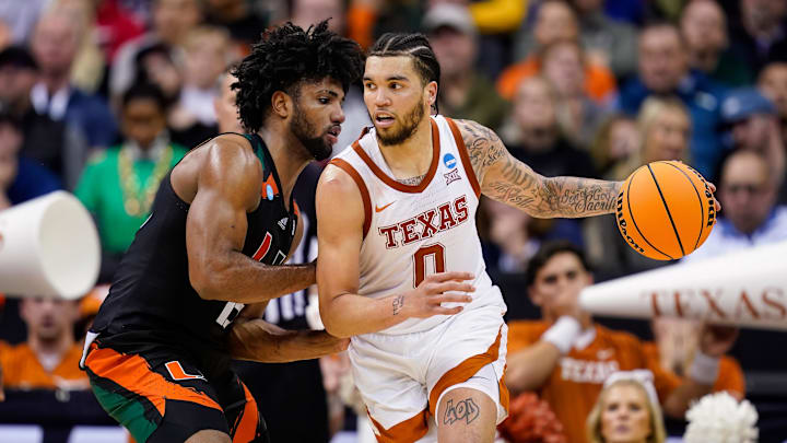 Mar 26, 2023; Kansas City, MO, USA; Texas Longhorns forward Timmy Allen (0) dribbles the ball against Miami (Fl) Hurricanes forward Norchad Omier (15) during the second half of an Elite 8 college basketball game in the Midwest Regional of the 2023 NCAA Tournament at T-Mobile Center. Mandatory Credit: Jay Biggerstaff-Imagn Images Mar 26, 2023; Kansas City, MO, USA; Texas Longhorns forward Timmy Allen (0) dribbles the ball against Miami (Fl) Hurricanes forward Norchad Omier (15) during the second half of an Elite 8 college basketball game in the Midwest Regional of the 2023 NCAA Tournament at T-Mobile Center. Mandatory Credit: Jay Biggerstaff-Imagn Images