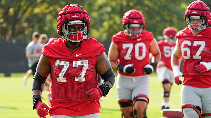 Aug 1, 2024; Columbus, OH, USA; Ohio State Buckeyes offensive lineman Tegra Tshabola (77) runs during football camp at the Woody Hayes Athletic Complex.