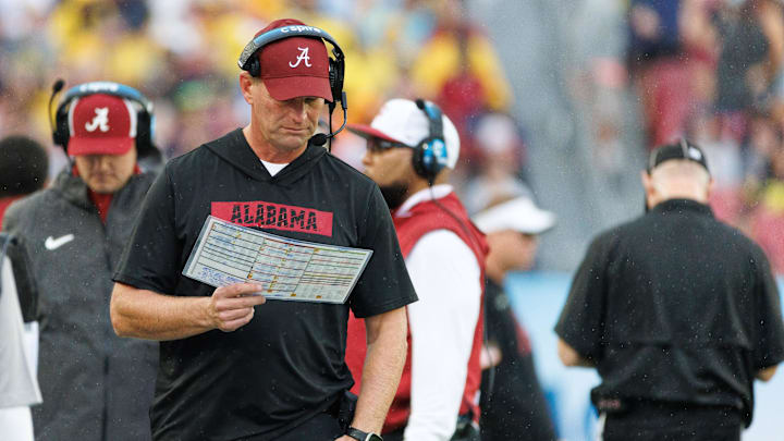 Dec 31, 2024; Tampa, FL, USA; Alabama Crimson Tide head coach Kalen DeBoer reads the playcard against the Michigan Wolverines during the first half at Raymond James Stadium. Mandatory Credit: Matt Pendleton-Imagn Images