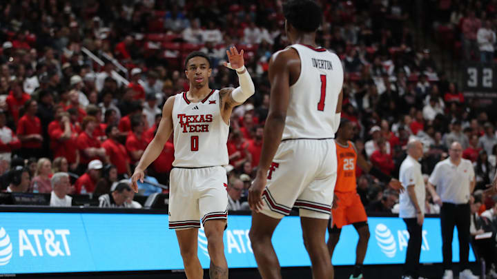 Jan 26, 2025; Lubbock, Texas, USA;  Texas Tech Red Raiders guard Chance McMillian (0) reacts with guard Kevin Overton (1) in the second half during the game against the Oklahoma State Cowboys at United Supermarkets Arena. Mandatory Credit: Michael C. Johnson-Imagn Images