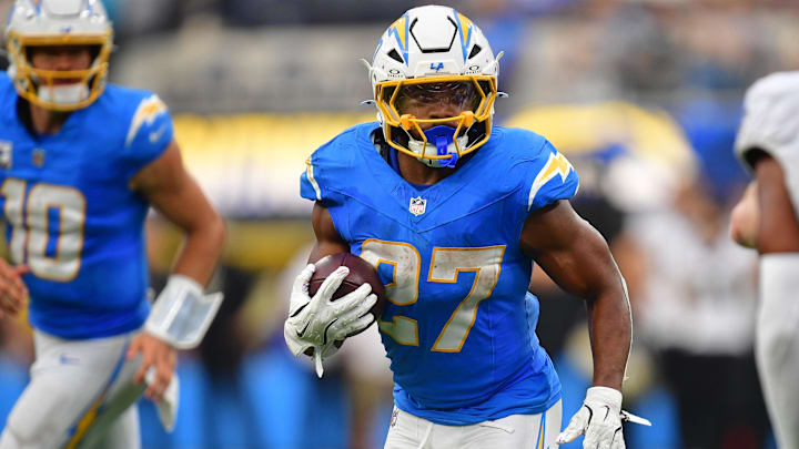 Oct 27, 2024; Inglewood, California, USA; Los Angeles Chargers running back J.K. Dobbins (27) runs the ball against the New Orleans Saints during the second half at SoFi Stadium. 