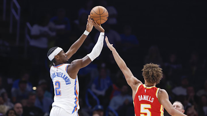 Oct 17, 2024; Oklahoma City, Oklahoma, USA; Oklahoma City Thunder guard Shai Gilgeous-Alexander (2) shoots a three point basket as Atlanta Hawks guard Dyson Daniels (5) defends during the second quarter at Paycom Center. Mandatory Credit: Alonzo Adams-Imagn Images Oct 17, 2024; Oklahoma City, Oklahoma, USA; Oklahoma City Thunder guard Shai Gilgeous-Alexander (2) shoots a three point basket as Atlanta Hawks guard Dyson Daniels (5) defends during the second quarter at Paycom Center. Mandatory Credit: Alonzo Adams-Imagn Images