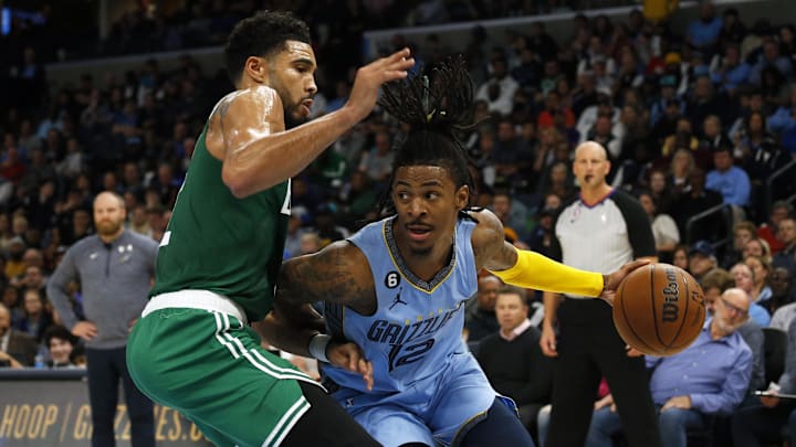 Memphis Grizzlies guard Ja Morant (12) drives to the basket as Boston Celtics forward Jayson Tatum (0) defends during the first half at FedExForum. Mandatory Credit: Petre Thomas-Imagn Images