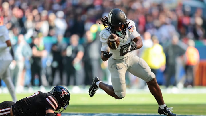 Jan 1, 2026; Miami Gardens, FL, USA; Oregon Ducks running back Noah Whittington (6) carries the ball as Texas Tech Red Raiders defensive back Brenden Jordan (7) defends during the first half of the 2025 Orange Bowl and quarterfinal game of the College Football Playoff at Hard Rock Stadium. Mandatory Credit: Sam Navarro-Imagn Images