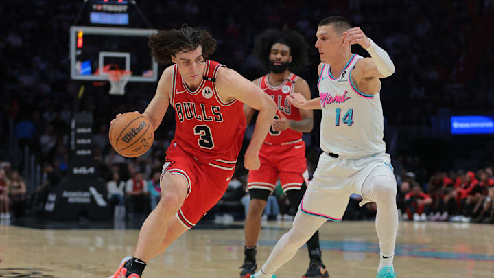 Mar 8, 2025; Miami, Florida, USA; Chicago Bulls guard Josh Giddey (3) drives to the basket against Miami Heat guard Tyler Herro (14) during the second quarter at Kaseya Center. Mandatory Credit: Sam Navarro-Imagn Images