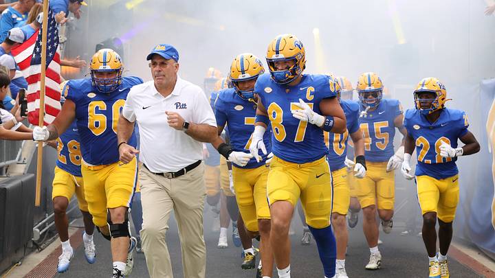 Sep 27, 2025; Pittsburgh, Pennsylvania, USA;  Pittsburgh Panthers head coach Pat Narduzzi (white) and tight end Jake Overman (87) lead the team onto the field to play the Louisville Cardinals at Acrisure Stadium. Mandatory Credit: Charles LeClaire-Imagn Images