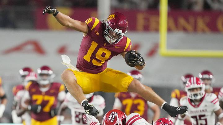 Sep 12, 2026; Los Angeles, California, USA; Southern California Trojans tight end Mark Bowman (19) leaps over Louisiana Ragin' Cajuns cornerback Avery Demery (10) and defensive lineman Priest Ashe (0) on a 35-yard reception in the first half at United Airlines Field at Los Angeles Memorial Coliseum. Mandatory Credit: Kirby Lee-Imagn Images