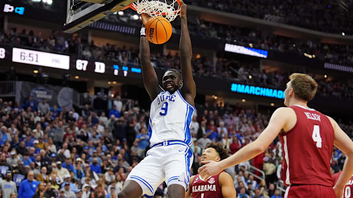 Mar 29, 2025; Newark, NJ, USA; Duke Blue Devils center Khaman Maluach (9) dunks the ball against Alabama Crimson Tide forward Grant Nelson (4) during the second half in the East Regional final of the 2025 NCAA tournament at Prudential Center. Mandatory Credit: Robert Deutsch-Imagn Images