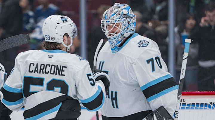Mar 16, 2025; Vancouver, British Columbia, CAN; Utah Hockey Club forward Michael Carcone (53) and goalie Karel Vejmelka (70) celebrate their victory against the Vancouver Canucks at Rogers Arena. Mandatory Credit: Bob Frid-Imagn Images