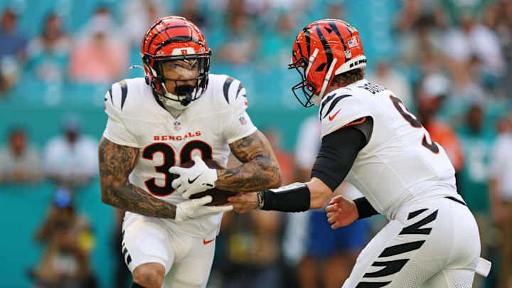 Dec 21, 2025; Miami Gardens, Florida, USA; Cincinnati Bengals quarterback Joe Burrow (9) hands off the ball to Cincinnati Bengals running back Chase Brown (30) during the first quarter at Hard Rock Stadium. Mandatory Credit: Nathan Ray Seebeck-Imagn Images
