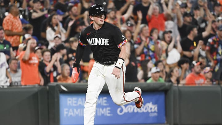 Jun 29, 2024; Baltimore, Maryland, USA;  Baltimore Orioles catcher Adley Rutschman (35) scores in the eighth inning against the Texas Rangersat Oriole Park at Camden Yards.